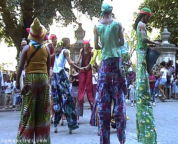 Street entertainment troupe with furious drumming & dancing on stilts