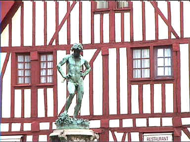 Statue at Place Francois Rude. Old facade in the background