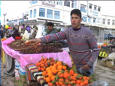 Fruit seller offering a sample