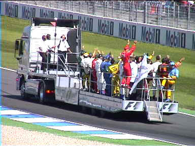 Before the race, all the drivers were paraded around the track on this truck. Schumacher's the guy in red waving at the spectators gone wild