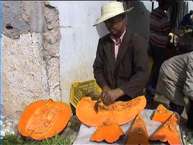 Cutting huge pumpkins at Midoun market