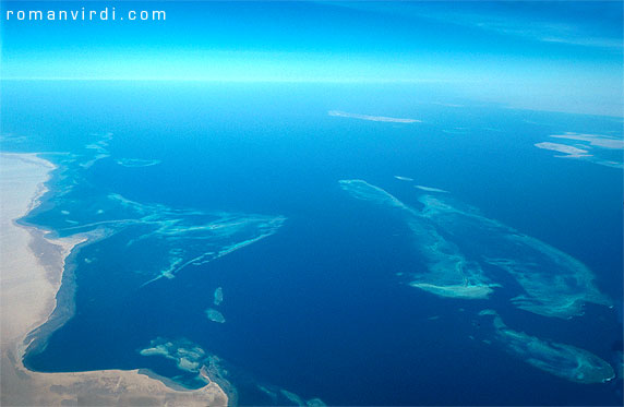Gulf of Suez: Shaab Ali from the air. The land mass to the left is the Sinai. The triangular reef is Sha'ab el Deqayeq. The star wreck in this area is of course the Thistlegorm, which lies between Deqayeq and the longish twin reefs next to it. The right one of the twin reefs is Sha'ab Ali. The northernmost of the two small blue islands immediately above Sha'ab Ali  is Shag Rock, home to the wreck of the Sarah H. 