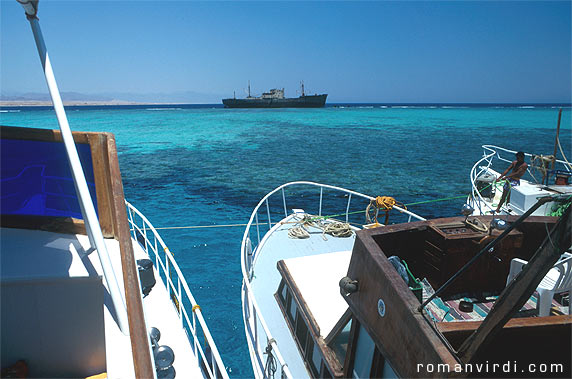 Dive boats tied up in the turquoise waters at the straits of Tiran for the lunch rest 