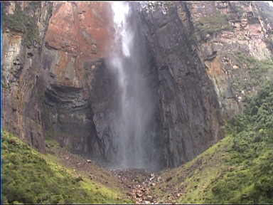 The bottom of Angel Falls. The water falls into a large concave half-cylinder. From afar, the water seems to have changed to mist